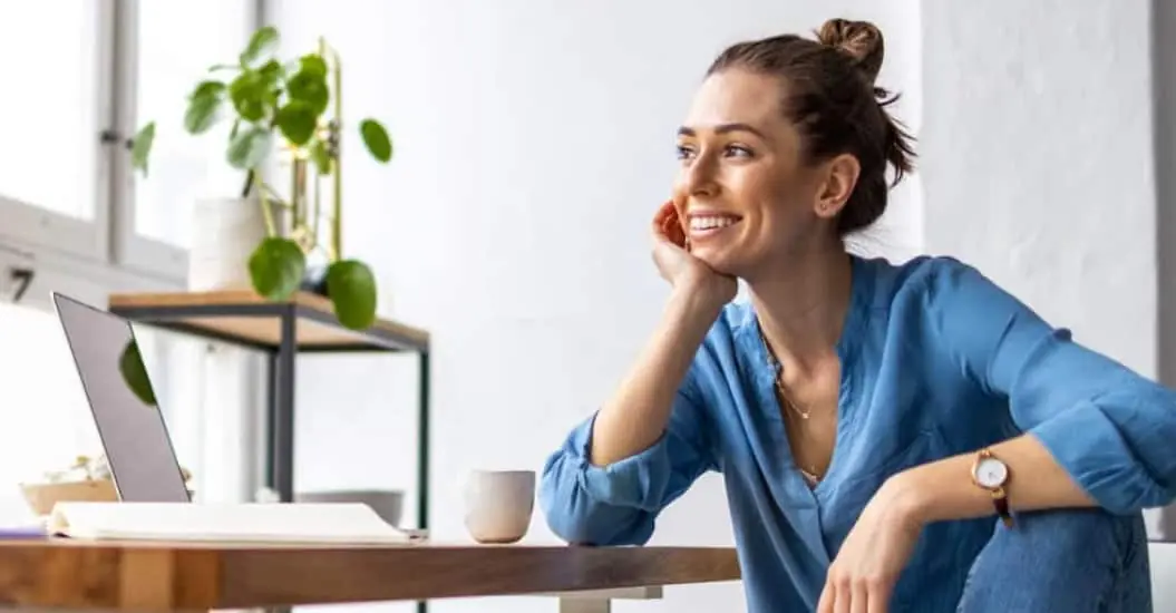 Woman working at her desk looking out the window