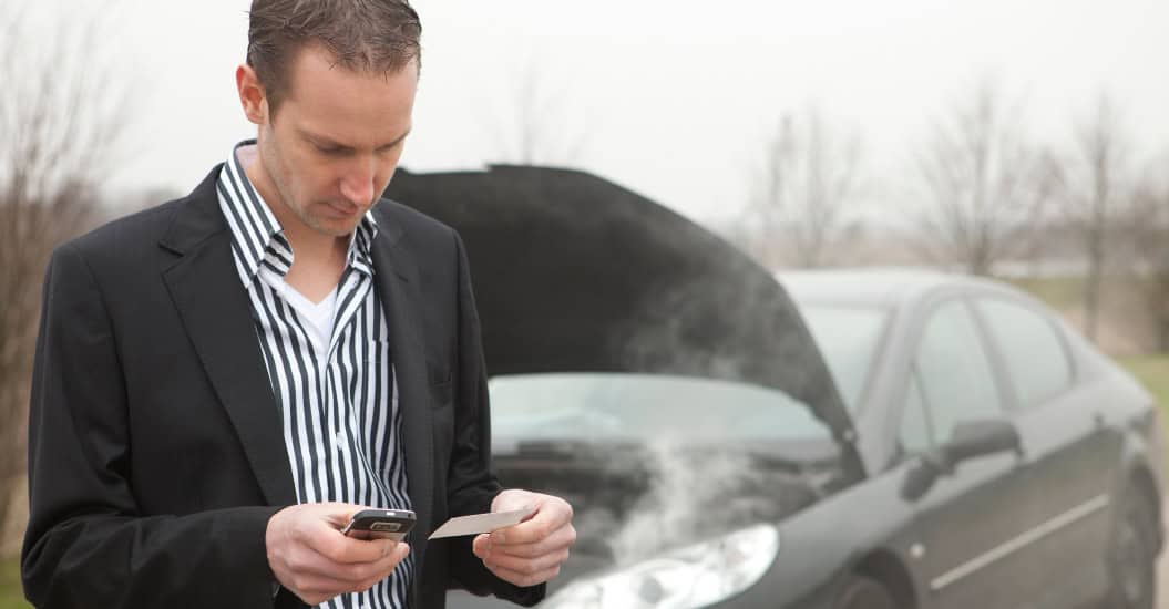 Man whose engine has overheated using his mobile to call for help