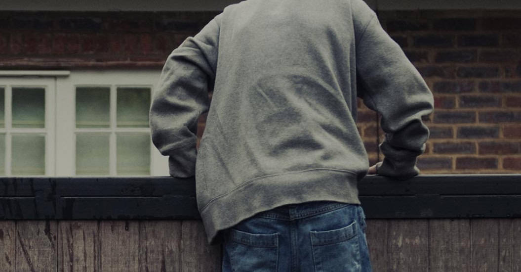 Man climbing fence to burgle house