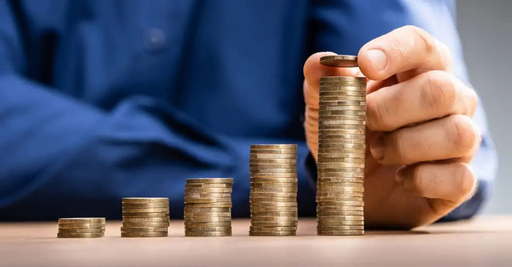 Man stacking piles of coins