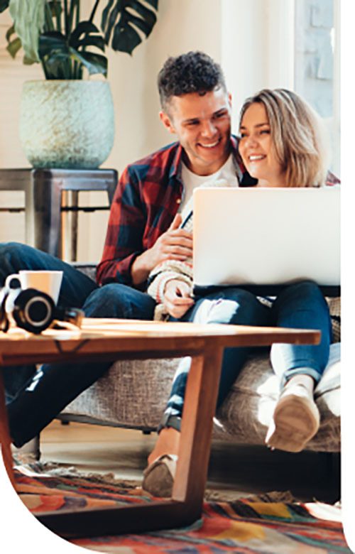 Couple sitting together doing their insurance online