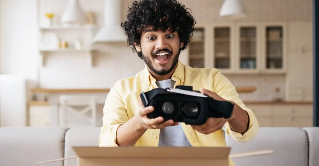 Young man excitedly opening boxed gift