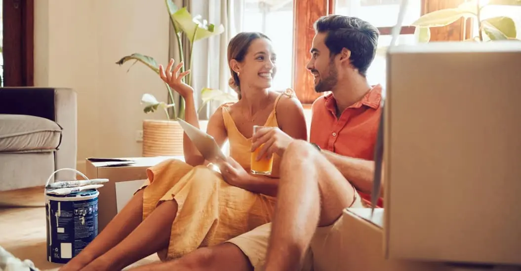 Couple taking a break from painting and renovating their home