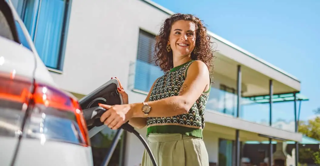 Woman charging her electric vehicle