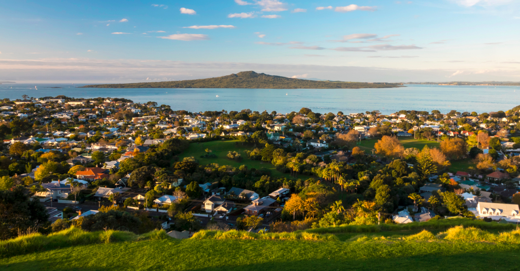 Aerial view of Rangitoto Island and Auckland coastal homes